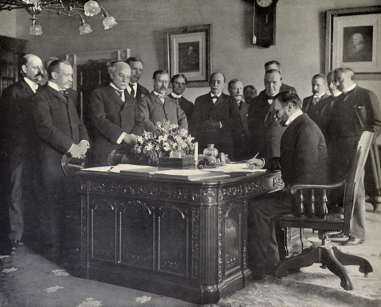 John Hay signs the Treaty of Paris in 1899. 