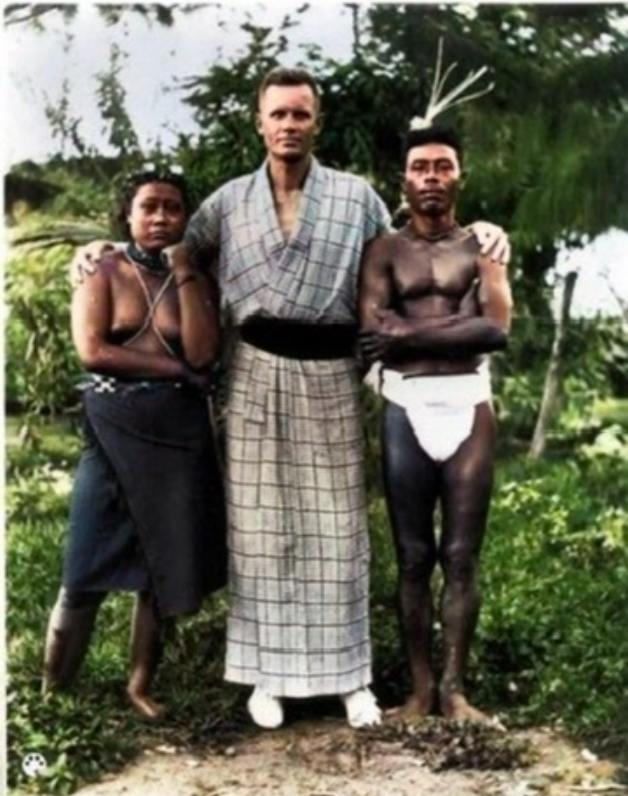 Hans Hornbostel poses with two local residents